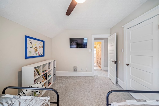 bedroom with lofted ceiling, baseboards, ceiling fan, a textured ceiling, and carpet flooring