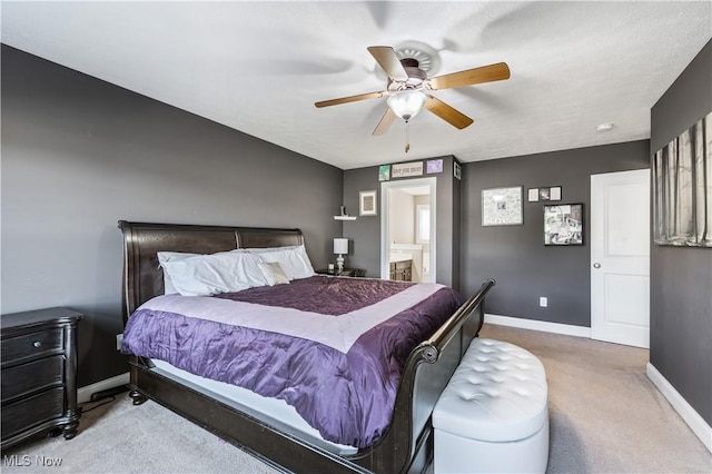 carpeted bedroom featuring baseboards, ceiling fan, and connected bathroom