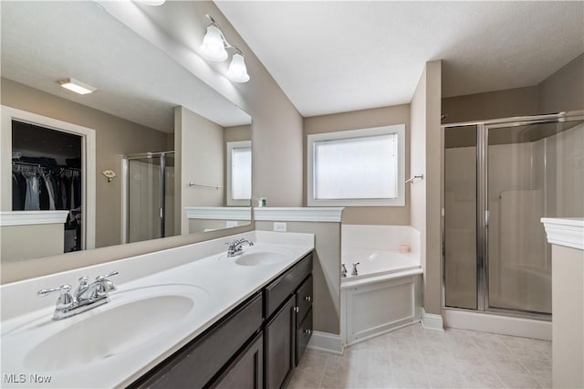 full bathroom with double vanity, a sink, a garden tub, and a stall shower