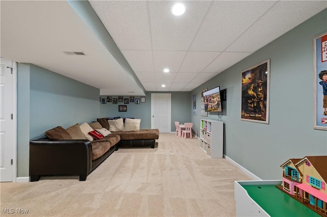 carpeted living area featuring visible vents, recessed lighting, baseboards, and a drop ceiling