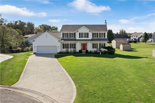 view of front facade featuring a garage, a front lawn, covered porch, a storage unit, and driveway