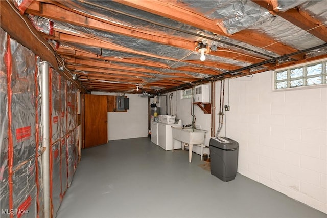 below grade area featuring washing machine and clothes dryer and electric panel