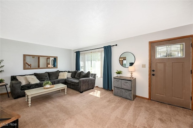 living area with light colored carpet, baseboards, and a wealth of natural light