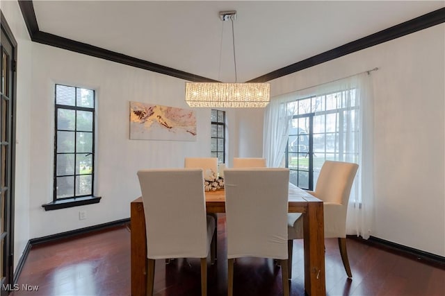dining space with crown molding, baseboards, a notable chandelier, and dark wood-type flooring
