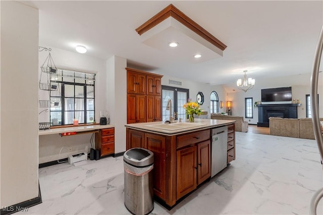 kitchen featuring a sink, marble finish floor, a chandelier, and dishwasher