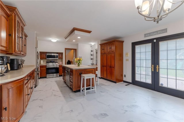 kitchen with a kitchen island, french doors, appliances with stainless steel finishes, brown cabinets, and marble finish floor