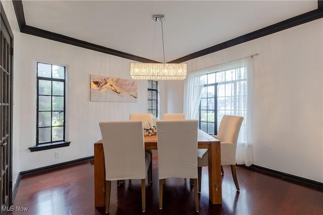 dining room with a chandelier, ornamental molding, wood finished floors, and a wealth of natural light