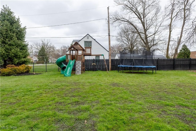 view of yard featuring a fenced backyard, a trampoline, and a playground