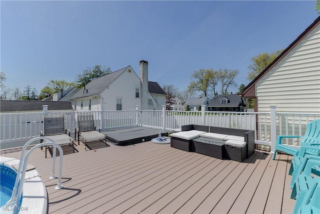 wooden terrace with an outdoor living space