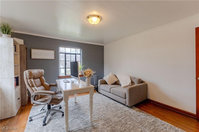 home office featuring crown molding, baseboards, and wood finished floors