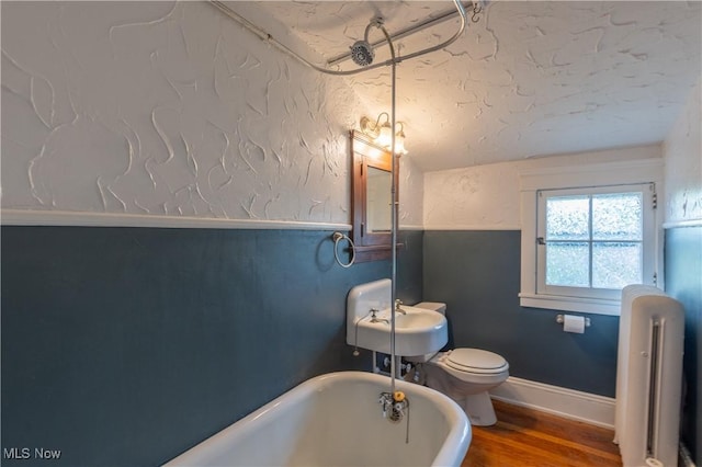 2155 Middlefield Rd, Cleveland Heights, OH 44106 - full bath featuring vaulted ceiling, wood finished floors, toilet, radiator, and a soaking tub