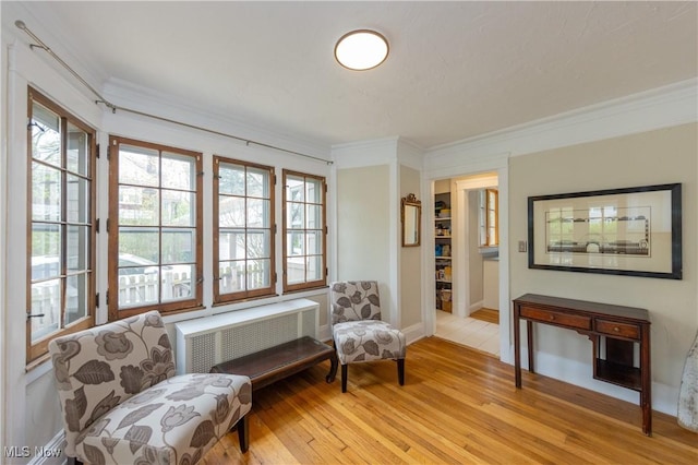 2155 Middlefield Rd, Cleveland Heights, OH 44106 - living area with crown molding, baseboards, radiator, and light wood-type flooring
