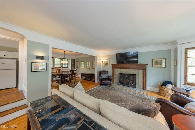 2155 Middlefield Rd, Cleveland Heights, OH 44106 - living area featuring ornamental molding, wood finished floors, and a fireplace