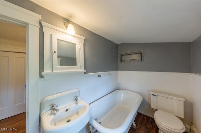 2155 Middlefield Rd, Cleveland Heights, OH 44106 - bathroom with a sink, toilet, a wainscoted wall, wood finished floors, and a soaking tub