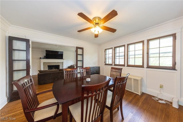2155 Middlefield Rd, Cleveland Heights, OH 44106 - dining space featuring a ceiling fan, crown molding, a brick fireplace, wood finished floors, and baseboards