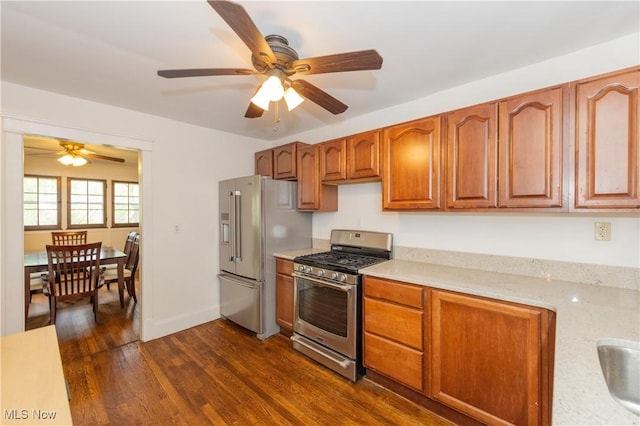 2155 Middlefield Rd, Cleveland Heights, OH 44106 - kitchen featuring baseboards, dark wood-style floors, brown cabinets, a ceiling fan, and stainless steel appliances