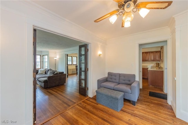 2155 Middlefield Rd, Cleveland Heights, OH 44106 - living room featuring light wood-style floors, ornamental molding, and a ceiling fan