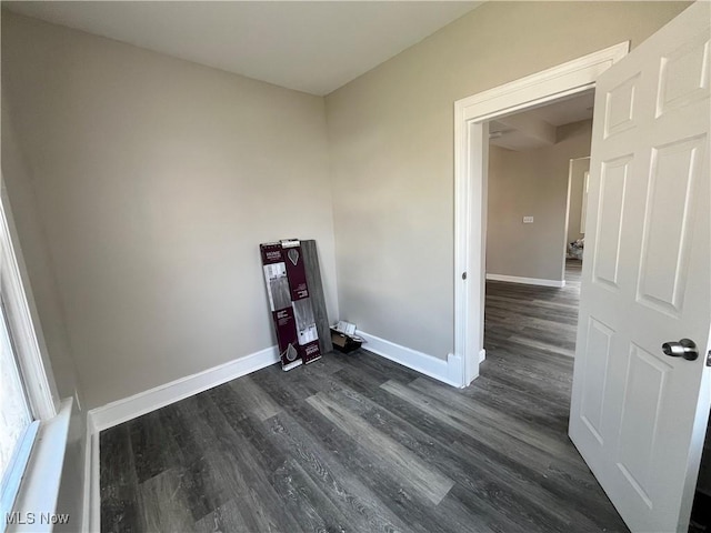 10402 Almira Ave, Cleveland, OH 44111 - laundry area with baseboards and dark wood-type flooring