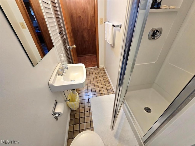 5294 Cottage Dr, Mecca, OH 44410 - bathroom with baseboards, a sink, tile patterned floors, and a shower stall