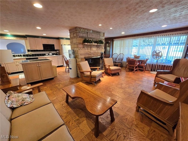 5294 Cottage Dr, Mecca, OH 44410 - living area featuring recessed lighting, a textured ceiling, and a fireplace
