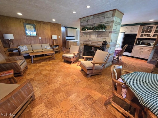 5294 Cottage Dr, Mecca, OH 44410 - living room featuring a textured ceiling, recessed lighting, and a stone fireplace