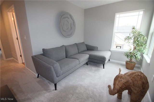 carpeted living room with baseboards