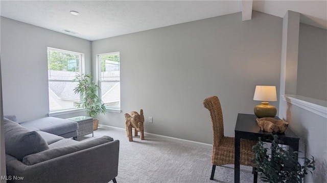 home office featuring carpet floors, baseboards, visible vents, and vaulted ceiling with beams