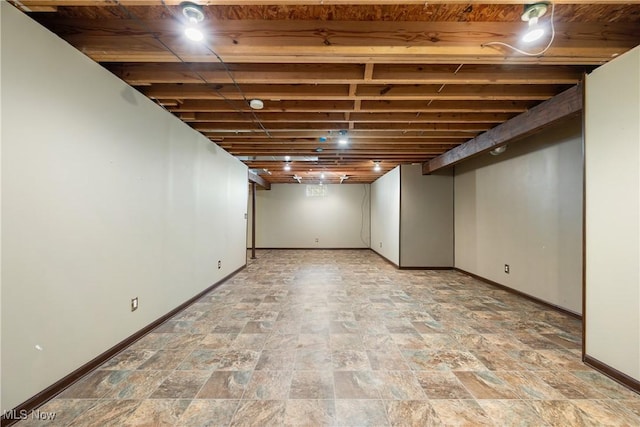 finished basement with baseboards and stone finish flooring