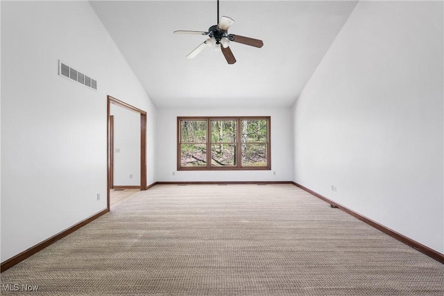 carpeted spare room featuring ceiling fan, visible vents, baseboards, and high vaulted ceiling