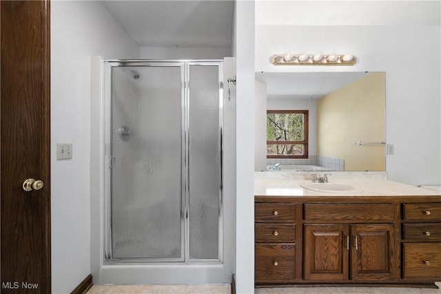 full bath with a shower stall and vanity