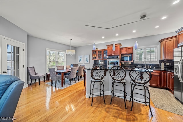 1432 Lake Vue Dr, Roaming Shores, OH 44085 - kitchen with appliances with stainless steel finishes, a kitchen breakfast bar, recessed lighting, a wealth of natural light, and backsplash