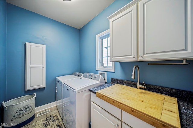 1432 Lake Vue Dr, Roaming Shores, OH 44085 - laundry room with washer and dryer, baseboards, cabinet space, and visible vents
