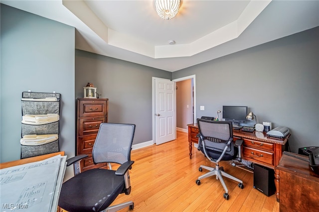1432 Lake Vue Dr, Roaming Shores, OH 44085 - home office featuring baseboards, a tray ceiling, and light wood finished floors
