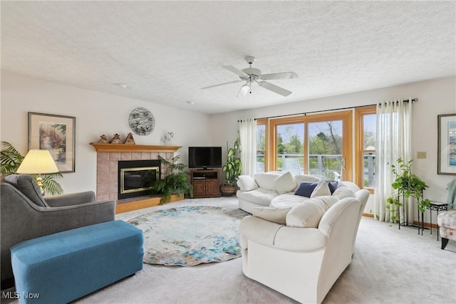 5420 Crystal Cove Cir, Stow, OH 44224 - carpeted living area featuring a ceiling fan, a textured ceiling, and a tile fireplace