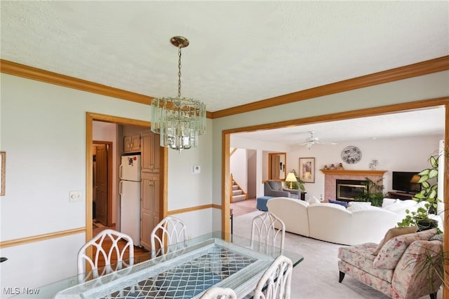 5420 Crystal Cove Cir, Stow, OH 44224 - dining space featuring crown molding, a notable chandelier, light carpet, a glass covered fireplace, and stairway