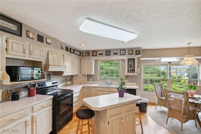 5420 Crystal Cove Cir, Stow, OH 44224 - kitchen with electric range, a breakfast bar, light countertops, a textured ceiling, and custom range hood