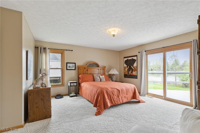 5420 Crystal Cove Cir, Stow, OH 44224 - carpeted bedroom with a textured ceiling, multiple windows, and access to exterior