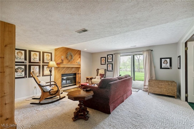 5420 Crystal Cove Cir, Stow, OH 44224 - carpeted living area with visible vents, a textured ceiling, and a glass covered fireplace
