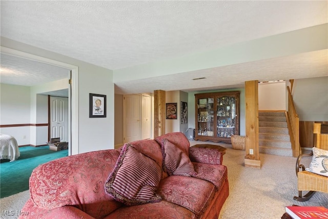 5420 Crystal Cove Cir, Stow, OH 44224 - living area with carpet flooring, stairs, and a textured ceiling