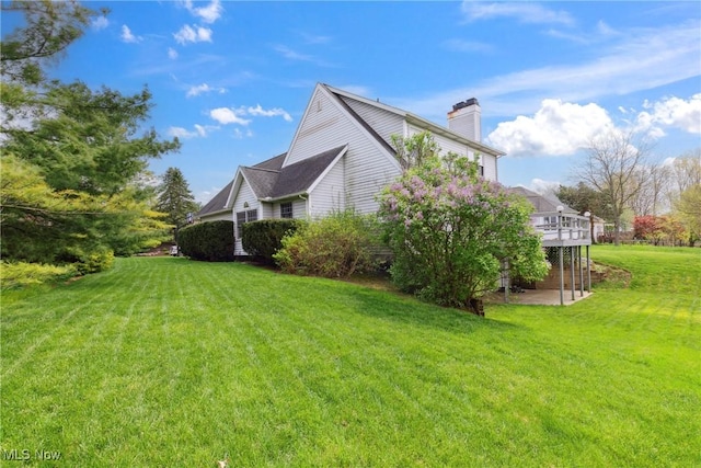 5420 Crystal Cove Cir, Stow, OH 44224 - view of side of property featuring a lawn, a wooden deck, and a chimney