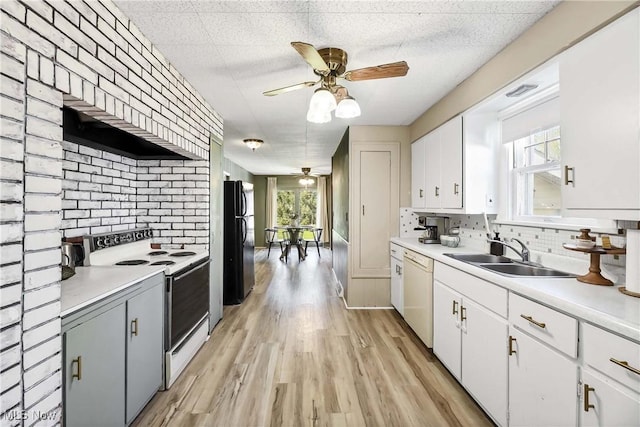 kitchen featuring a ceiling fan, tasteful backsplash, a sink, light countertops, and white appliances