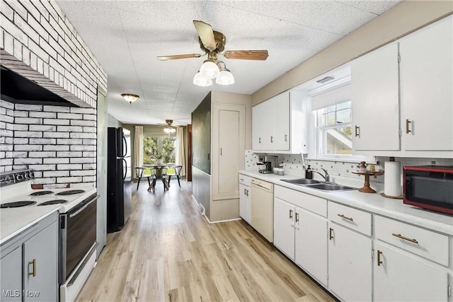 kitchen featuring a ceiling fan, white appliances, light countertops, a sink, and backsplash