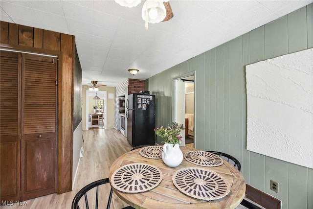 dining room featuring a ceiling fan and light wood-style floors