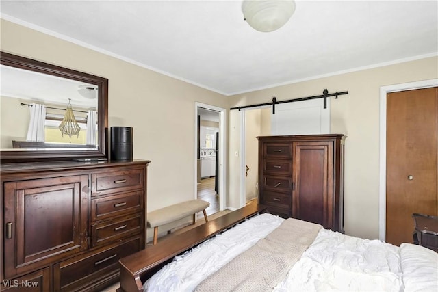 bedroom with a barn door and ornamental molding