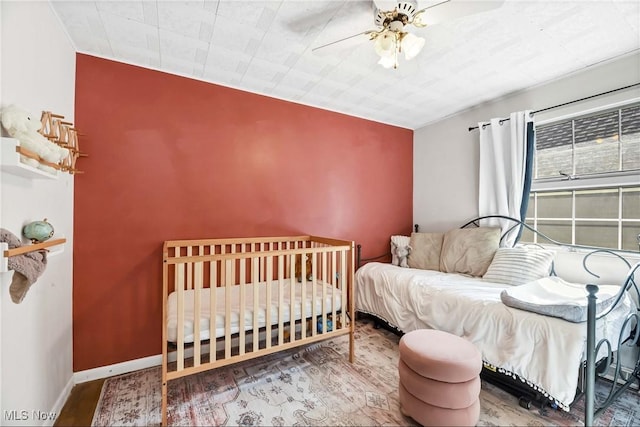 bedroom featuring a ceiling fan and wood finished floors