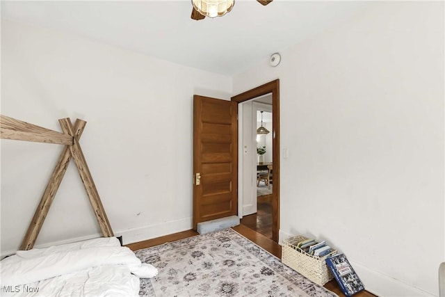 bedroom with baseboards and wood finished floors