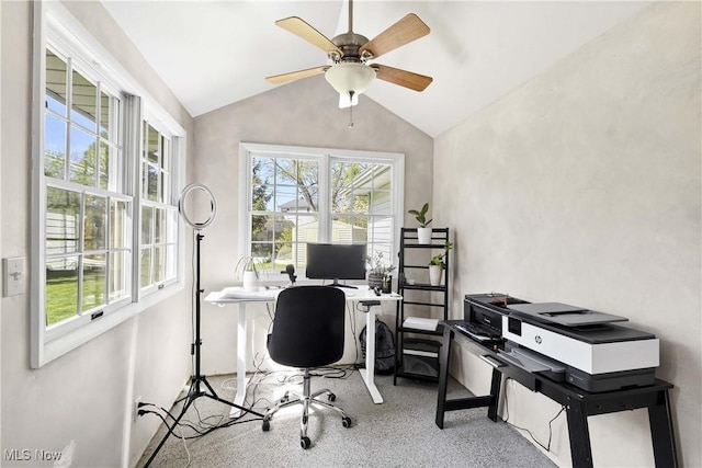 carpeted office featuring a ceiling fan and vaulted ceiling