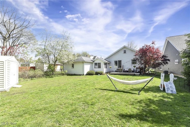 back of property featuring a yard and fence