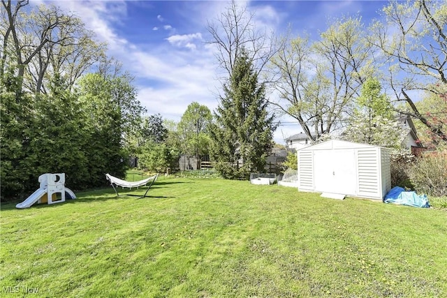 view of yard with a storage shed and an outdoor structure
