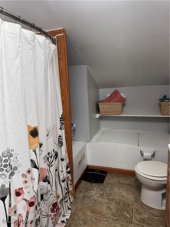 full bathroom with curtained shower, vaulted ceiling, and toilet